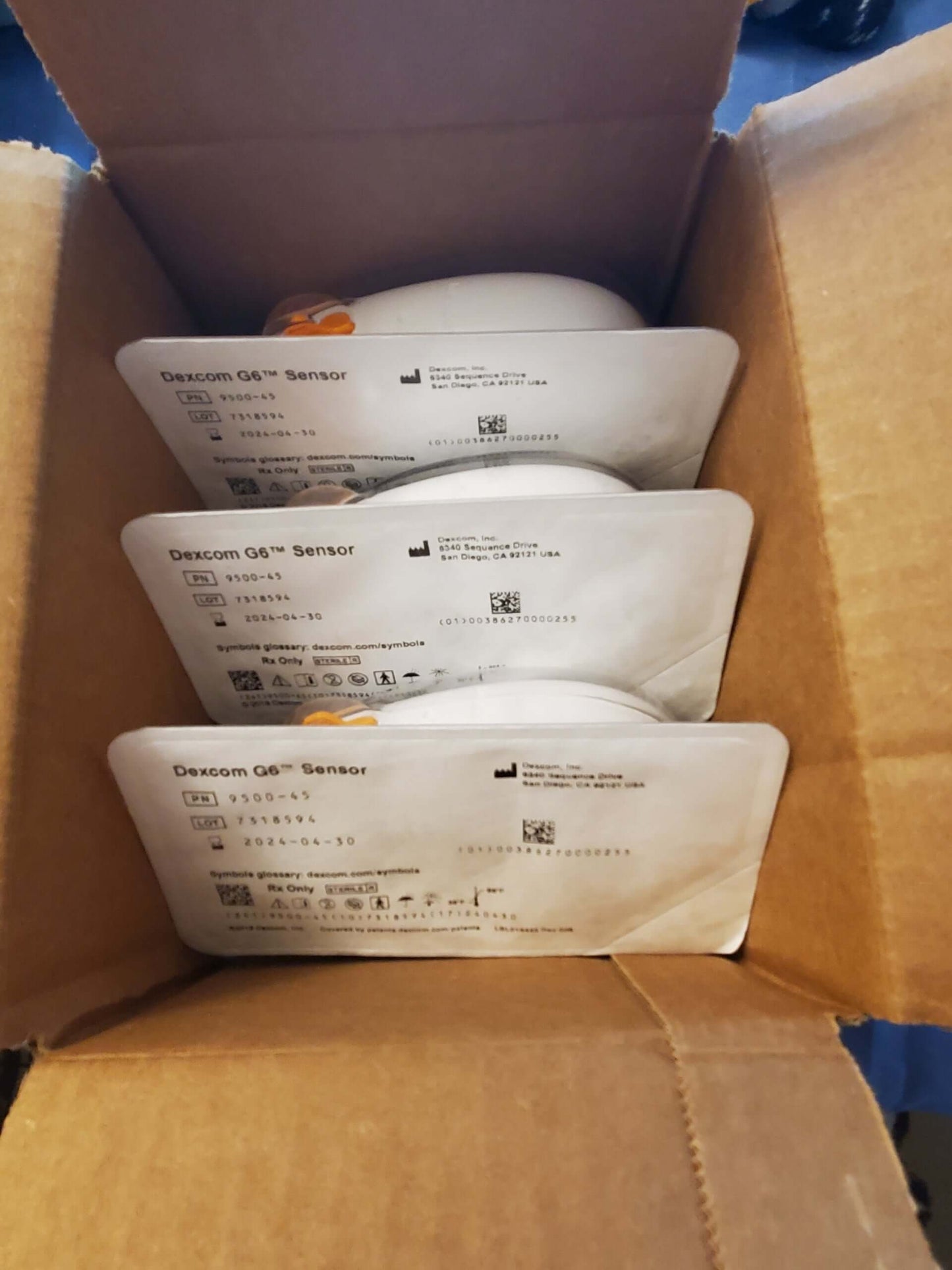 Three individually sealed Dexcom G6 sensors in a cardboard box, no retail packaging, new with early expiration dates.
